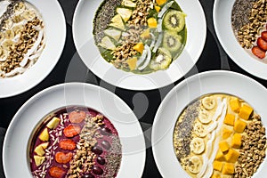 A selection of five different Smoothie bowl with different fruits, yogurt, granola and nut seeds