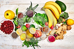 Selection of food rich in antioxidants and vitamins and mineral sources, vegan food on white wooden background. Healthy balanced