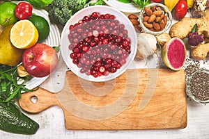 Selection food of rich in antioxidants and vitamins and mineral sources, on white wooden background around cutting board. Healthy