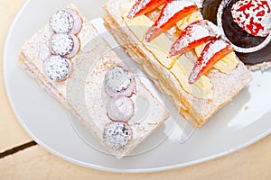 Selection of fresh cream cake dessert plate