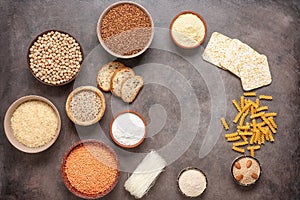 Selection of gluten free food on a brown rustic background. A variety of grains, flours, pasta, and bread gluten-free. Top view,