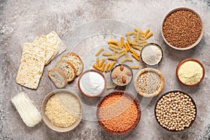 Selection of gluten free food on a rustic background. A variety of grains, flours, pasta, and bread gluten-free. Top