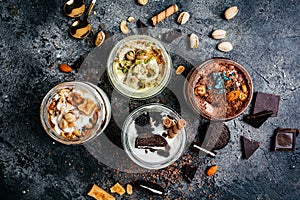 Selection of gourmet flavours of Italian ice cream served in jar on dark rustic table in an ice cream parlor, banner, menu, recipe