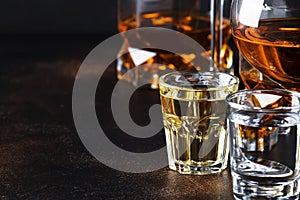 Selection of hard alcoholic drinks in big glasses and small shot glass in assortent: vodka, rum, cognac, tequila, brandy and