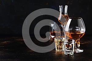 Selection of hard alcoholic drinks in big glasses and small shot glass in assortent: vodka, rum, cognac, tequila, brandy and