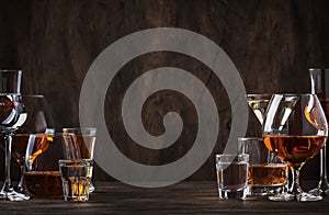 Selection of hard strong alcoholic drinks in big glasses and small shot glass in assortent: vodka, cognac, tequila, brandy and