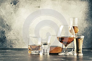 Selection of hard strong alcoholic drinks in big glasses and small shot glass in assortent: vodka, cognac, tequila, brandy and