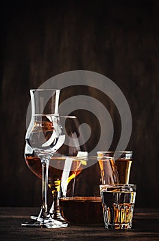 Selection of hard strong alcoholic drinks in big glasses and small shot glass in assortent: vodka, cognac, tequila, brandy and