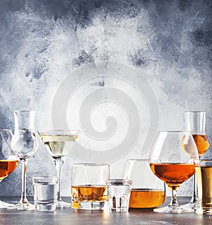 Selection of hard strong alcoholic drinks in big glasses and small shot glass in assortent: vodka, rum, cognac, tequila, brandy