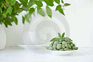 Selection of healthy food for heart, life concept. green nuts on wasaby or canabis coat on pure white background