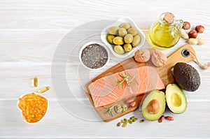 Selection of healthy unsaturated fats, omega 3 - fish, avocado, olives, nuts and seeds. photo