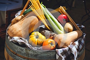 A selection of healthy winter vegetables on display on top of a barrel