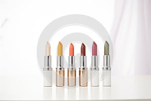 selection of highend lipsticks in a row against white