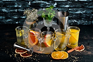 A selection of hot cocktails. Winter drinks. Hot wine. On a black wooden background.