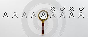 Selection of job candidates. Magnifying glass with abstract personas. Acceptance and rejection. photo
