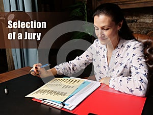 Selection of a Jury sign. Closeup portrait of unrecognizable successful Businesswoman wearing formal suit reading documents