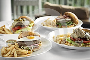 Selection of many different burgers on restaurant table