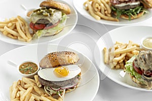 Selection of many different burgers on restaurant table