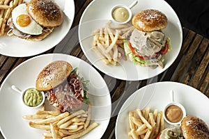 Selection of many different burgers on restaurant table