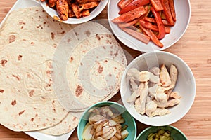 Selection of mexican food ingredients to add to soft flour tortilla at mealtime