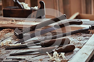 Selection of old tools on a woodworking workbench