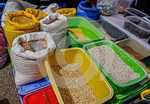 Selection of pluses, lentils and beans in containers and sacks
