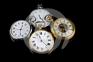 Selection of Pocket Watches on a Black Reflective Surface