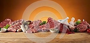 Selection of raw meats on rustic timber board