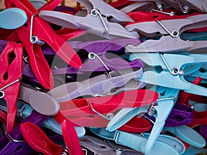 Selection of red purple blue and grey clothes pegs