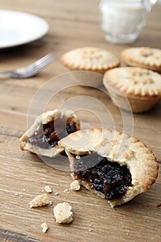 Selection of several mince pies, some broken open or partly eaten. A traditional festive Christmas dessert or pudding.