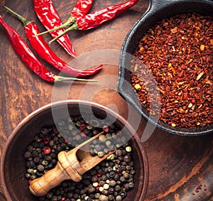 Selection of spices pepper. Food background on black wood table. Top view