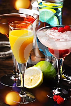 Selection of summer cocktails. Cold refreshing alcoholic beverages and drinks: mimosa, cosmopolitan, raspberry margarita and blue