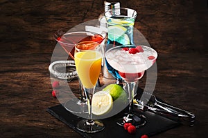 Selection of summer cocktails. Cold refreshing alcoholic beverages and drinks: mimosa, cosmopolitan, raspberry margarita and blue
