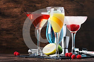 Selection of summer cocktails. Cold refreshing alcoholic beverages and drinks: mimosa, cosmopolitan, raspberry margarita and blue