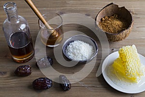 Selection of sweetener ingredients, including honey, sugar and maple syrup