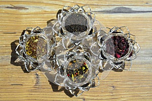 Selection of tea with rooibos, red berries and chai tea in blass lotus flower bowls