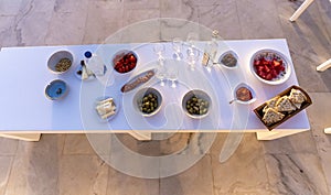 Selection of traditional greek aperitif, top view. olive,tomatoes,watermelon,pitas bread, cheese, ouzo