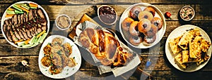 Selection of traditional hanukkah food for festive dinner, wood background