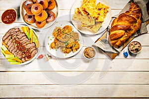 Selection of traditional hanukkah food for festive dinner, wood background