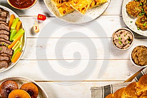 Selection of traditional hanukkah food for festive dinner, wood background