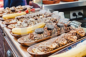 A selection of various delicious chocolate deserts for sale at a market stall