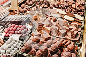 A selection of various delicious chocolate deserts for sale at a market stall