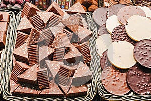 A selection of various delicious chocolate deserts for sale at a market stall