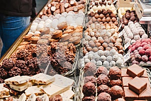 A selection of various delicious chocolate deserts for sale at a market stall