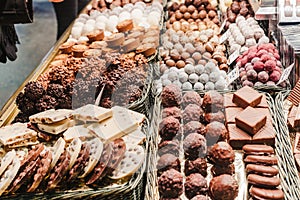 A selection of various delicious chocolate deserts for sale at a market stall