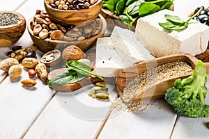 Selection of vegan plant protein sources - tofu, quinoa, spinach, broccoli, chia, nuts and seeds