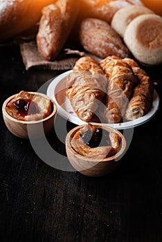 In selectiv focus of blurberry pie in wooden cup,vintage and art tone