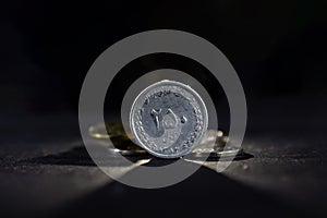 Selective blur on a 250 rials coin from Iran, isolated on a black background. IRR, or iranian rial, is the official currency and