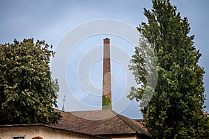Selective blur on Broken Red brick chimney from an abandoned factory dating back from the industrial revolution in a bankrupted