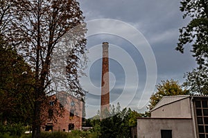 Selective blur on Broken Red brick chimney from an abandoned factory dating back from the industrial revolution in a bankrupted